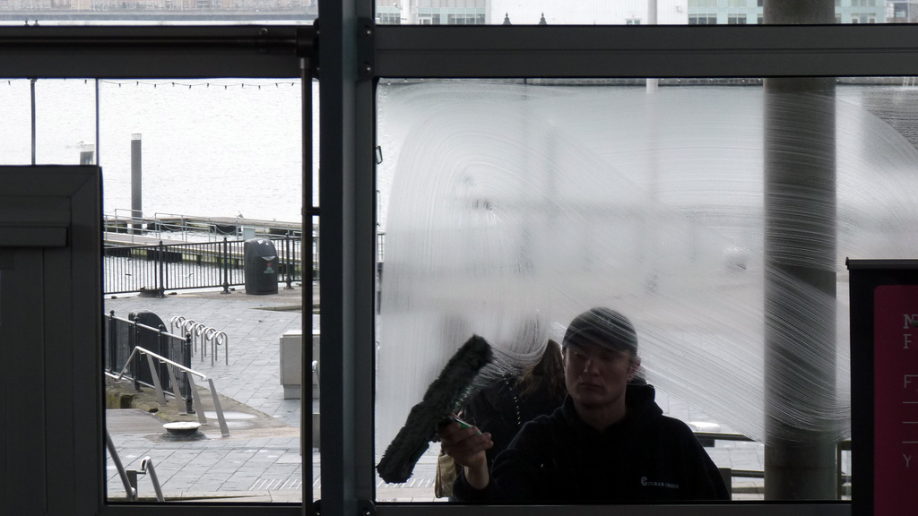 Photo of a man cleaning a window